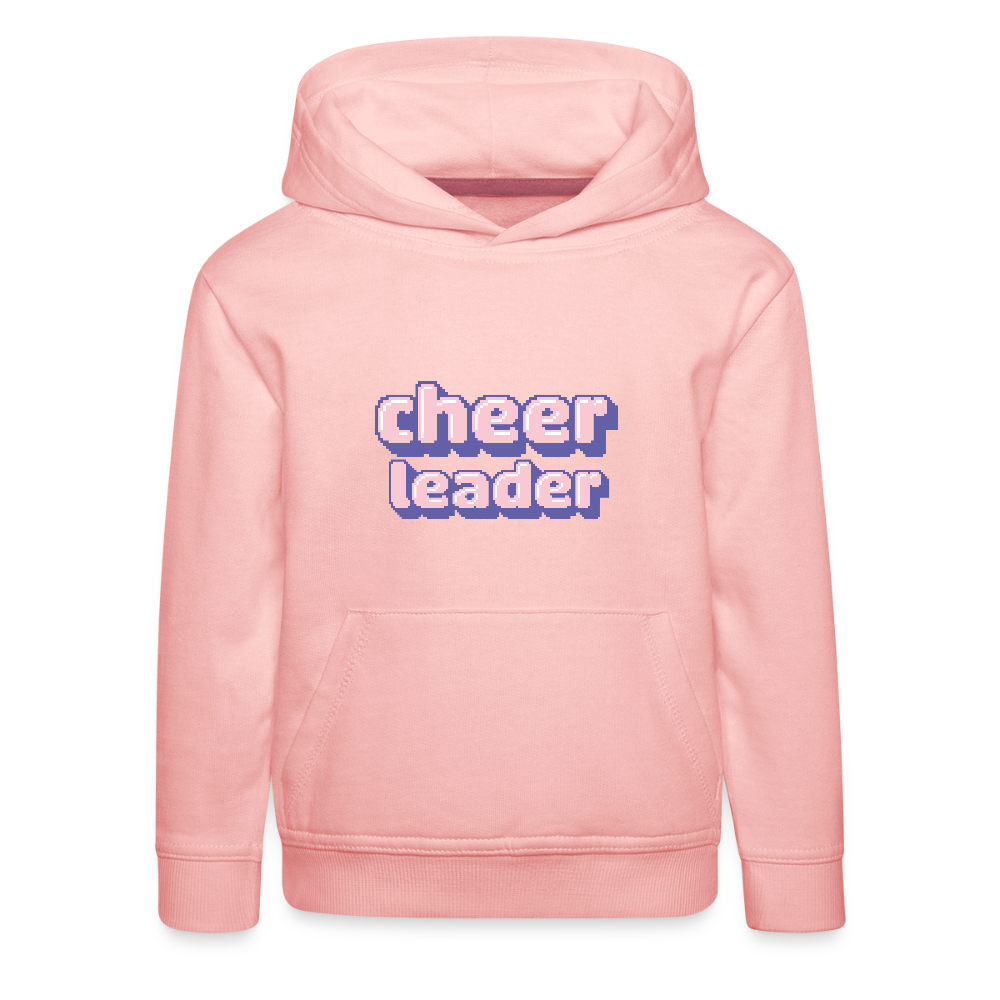 Kinder Hoodie mit Kapuze und Kangaroopocket.  Der Aufdurck ist: Cheerleader in lila,weiß, rosa Pixelschrif. Der Pullover ist rosa.