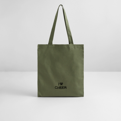Tote Bag mit der Aufschrift  I BOW (Schleifensymbol in Herzform) CHEER in schwarz auf khakifarbenem Stoff. Der Beutel steht vor einer weißen Wand auf weißem Untergrund.