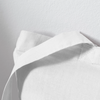 Details of white Totebag on white surface.