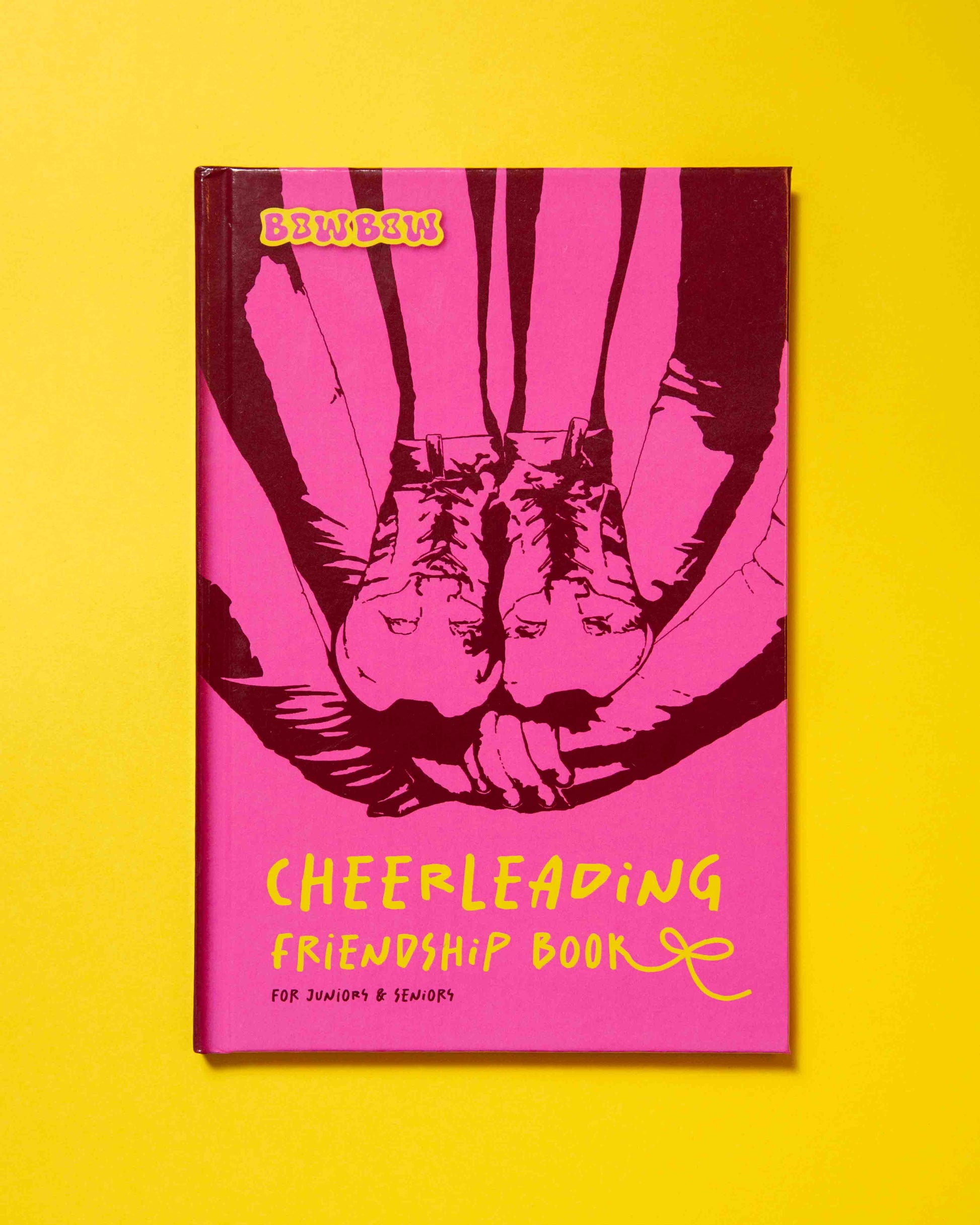 the Cover of the Book: CHEERLEADING FRIENDSHIP BOOK: for Juniors & Seniors is laying on yellow background.