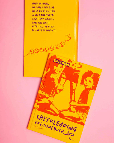 Cheerleading Friendship Book for Peewees. 2 Books on pink Background. You can see the Cover and the front.