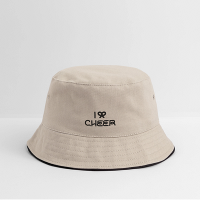 Zu sehen ist ein Bucket Hat in khaki/schwarz mit dem Aufdruck: I BOW (als Schleifensymbol) Cheer auf weißem Hintergrund